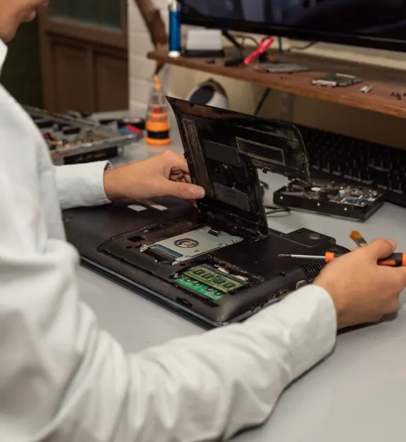 An IT worker checks a device to investigate issues.